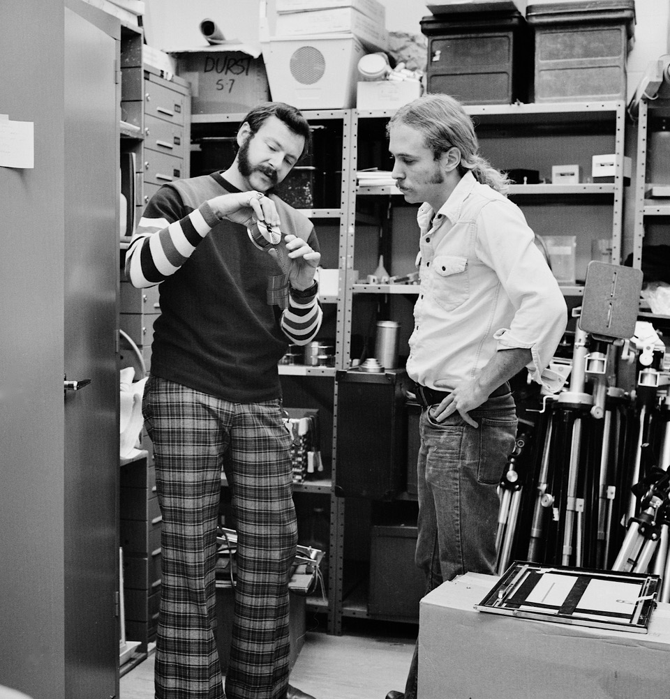 2 film students discussing equipment in the equipment room
